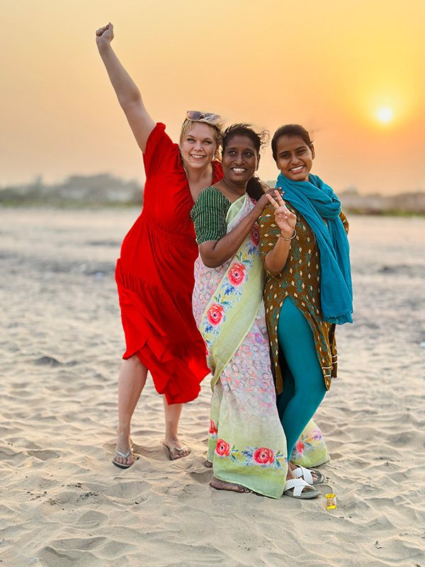 Henriikka with ladies on beach
